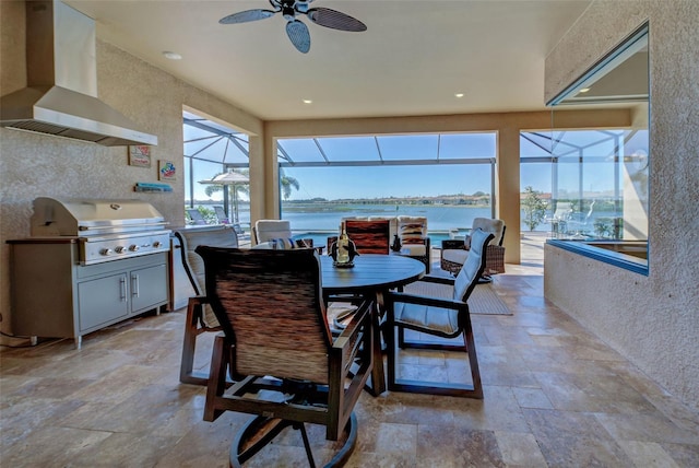 dining room featuring a water view and ceiling fan