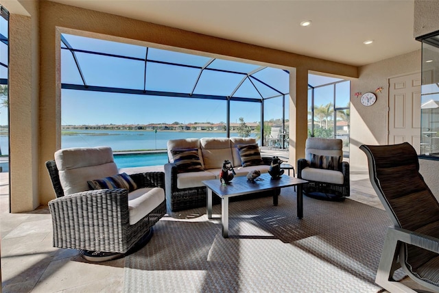 view of patio with an outdoor living space, a lanai, and a water view