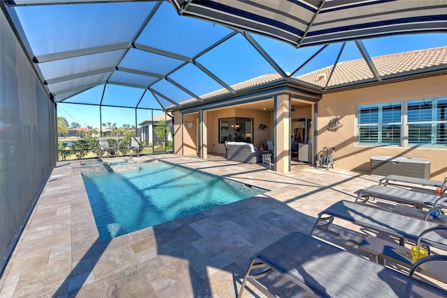 view of pool with a patio and glass enclosure