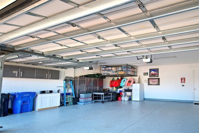 garage featuring a garage door opener and white fridge