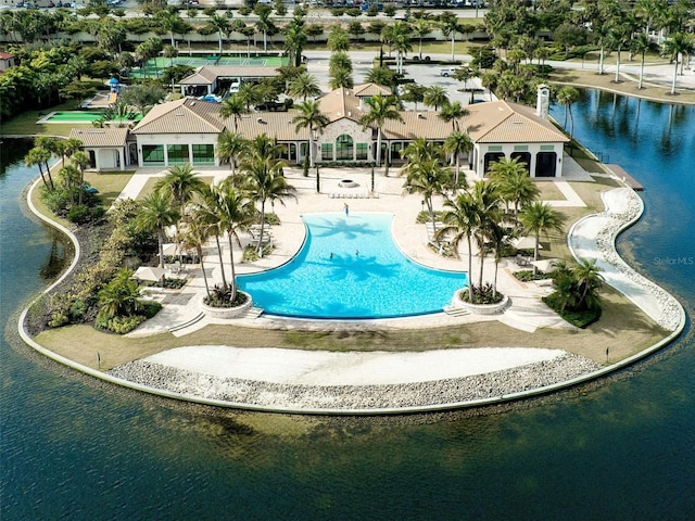 view of pool featuring a water view and a patio area