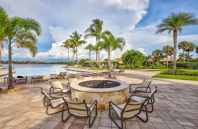 view of patio featuring a water view and an outdoor fire pit