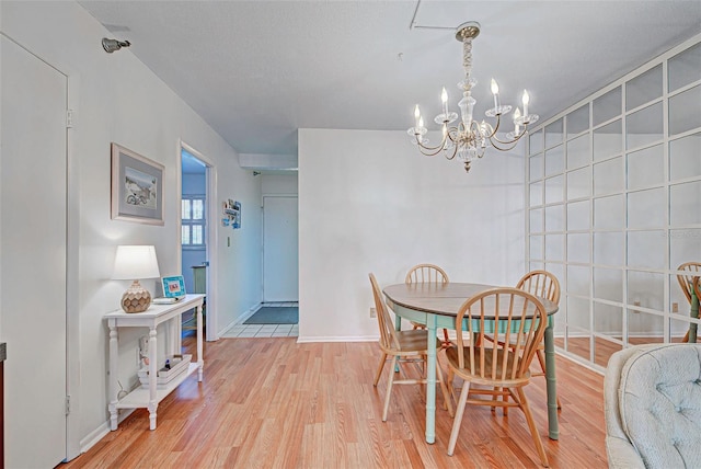 dining space with a chandelier and light hardwood / wood-style floors