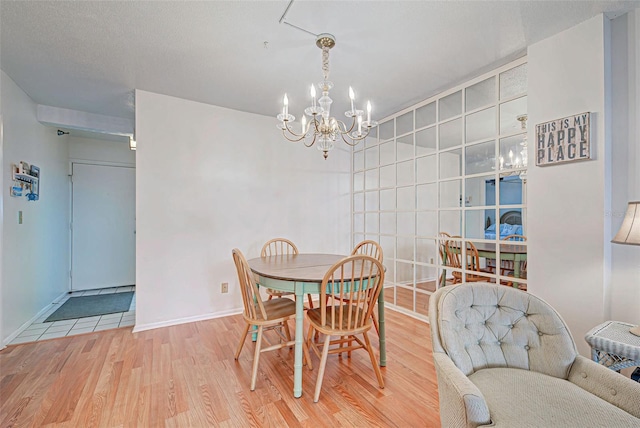 dining room with wood-type flooring and an inviting chandelier