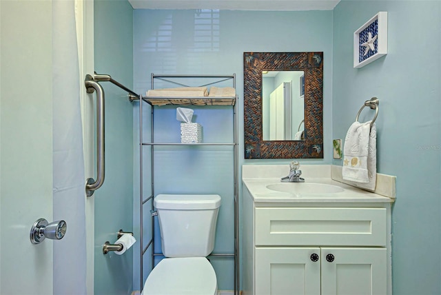 bathroom featuring toilet and vanity