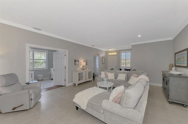 living room with light tile patterned floors, plenty of natural light, and ornamental molding