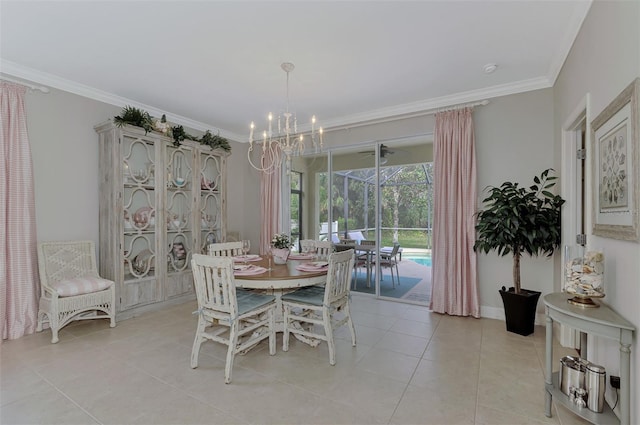 dining area with light tile patterned floors, ornamental molding, and a chandelier