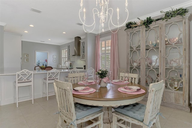 dining space with light tile patterned flooring, ornamental molding, sink, and a notable chandelier