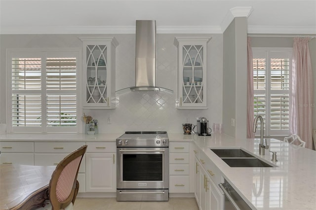 kitchen featuring white cabinets, appliances with stainless steel finishes, extractor fan, sink, and ornamental molding