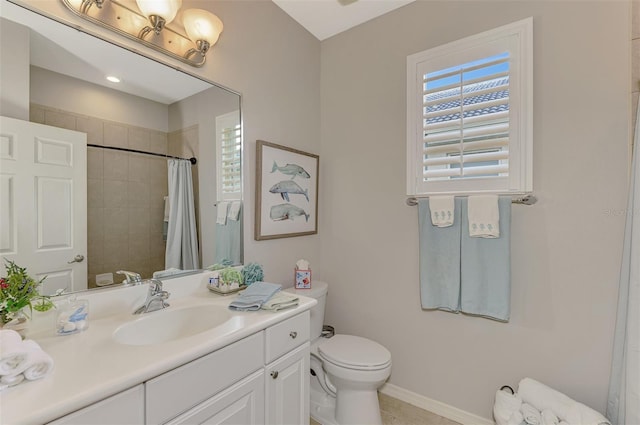 bathroom featuring toilet, vanity, and a shower with shower curtain