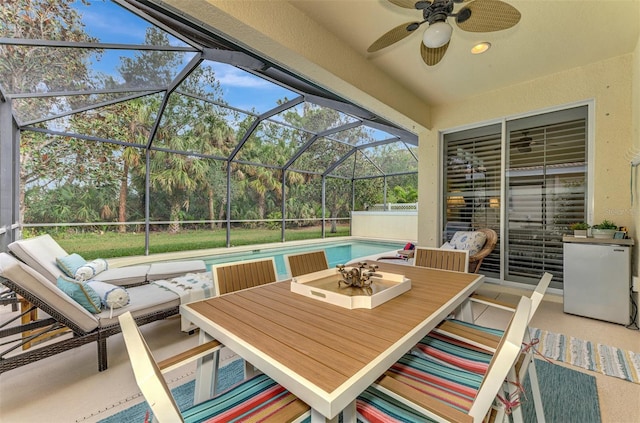 view of patio with glass enclosure and ceiling fan