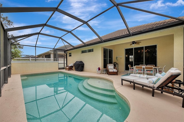 view of swimming pool with a lanai, ceiling fan, grilling area, and a patio