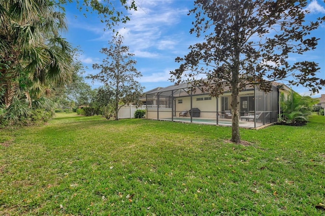 view of yard featuring a fenced in pool and glass enclosure