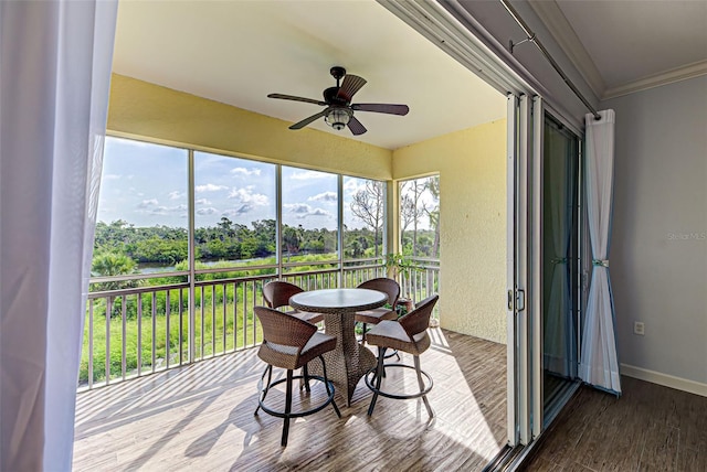 sunroom / solarium featuring ceiling fan