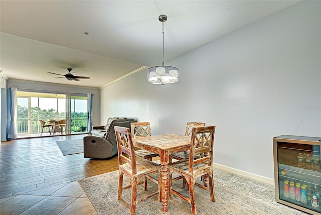 dining space with light wood-type flooring, ceiling fan, crown molding, and wine cooler