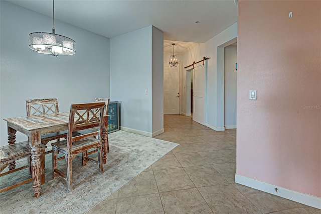 dining area with light tile patterned flooring and a barn door