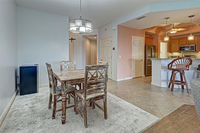 dining area featuring light tile patterned flooring and a chandelier