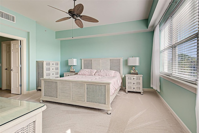 bedroom with ceiling fan and light carpet