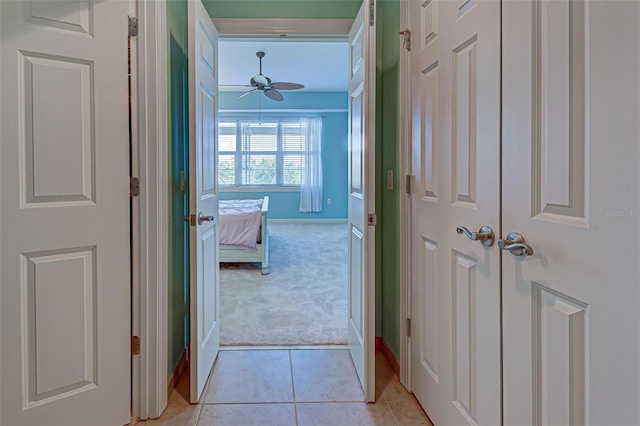 hallway featuring light carpet