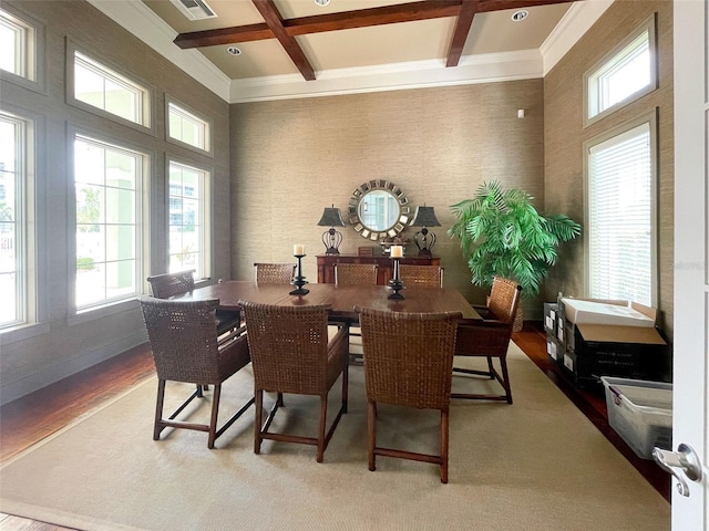 dining space with beam ceiling, wood-type flooring, a wealth of natural light, and coffered ceiling