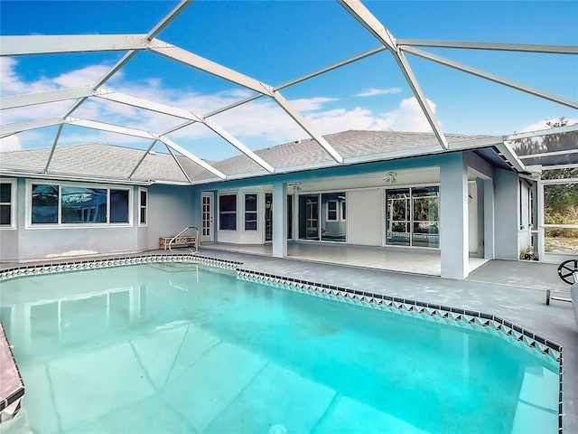 view of pool featuring glass enclosure and a patio area