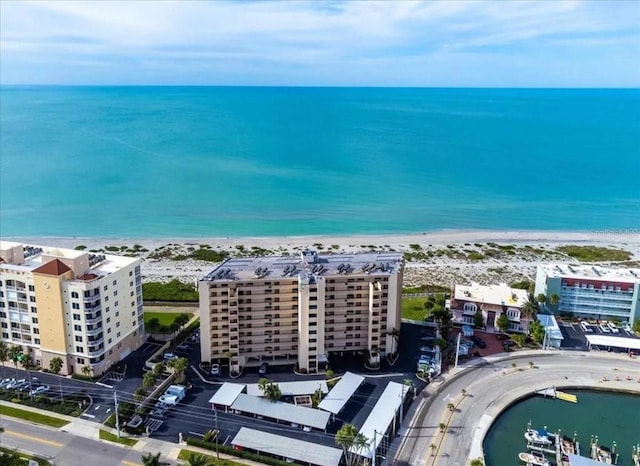 bird's eye view with a water view and a beach view