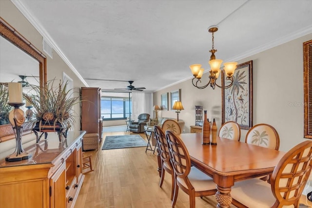 dining area featuring ornamental molding, ceiling fan with notable chandelier, and light hardwood / wood-style flooring