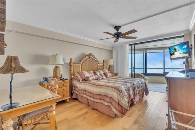 bedroom featuring ornamental molding, ceiling fan, and light hardwood / wood-style floors