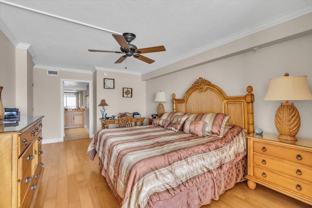 bedroom with crown molding, light hardwood / wood-style floors, ceiling fan, and ensuite bathroom