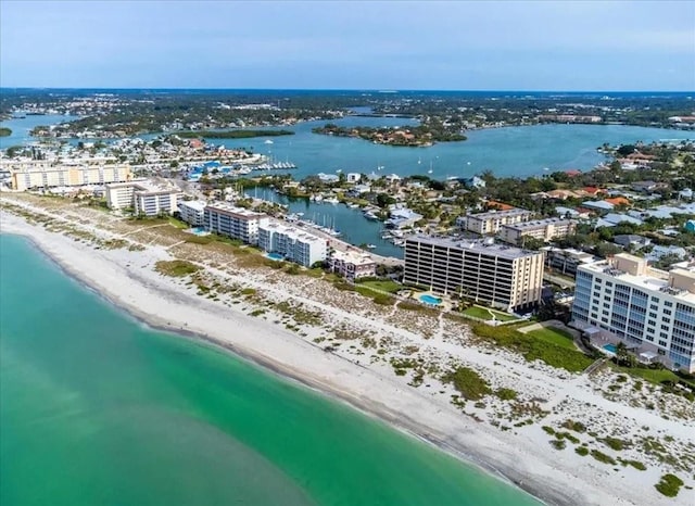 bird's eye view featuring a water view and a beach view