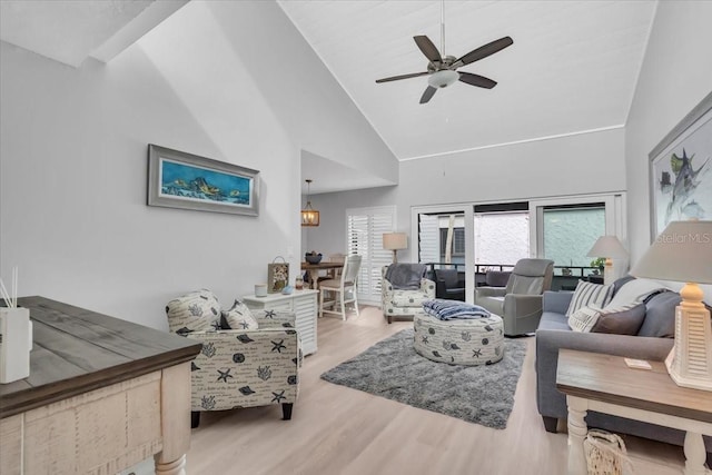 living room featuring ceiling fan, high vaulted ceiling, and light wood-type flooring