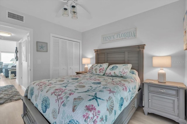 bedroom featuring ceiling fan, light hardwood / wood-style floors, and a closet