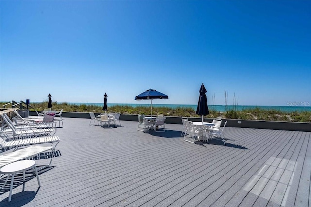 wooden terrace featuring a water view