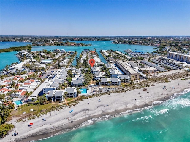 bird's eye view featuring a water view and a beach view