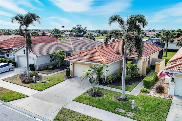 view of front of property with a garage and a front lawn