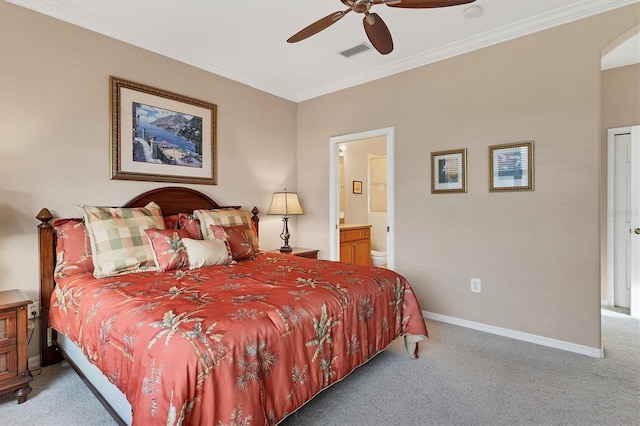 carpeted bedroom with ornamental molding, ensuite bathroom, and ceiling fan