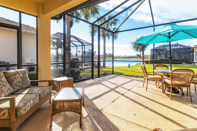 sunroom featuring a water view