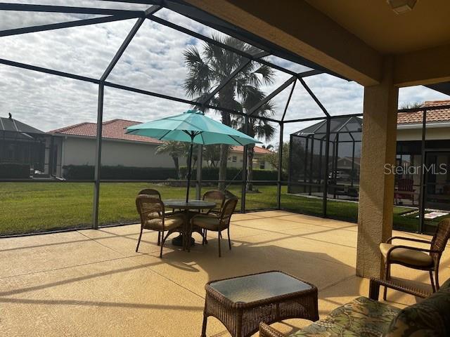 view of patio featuring glass enclosure