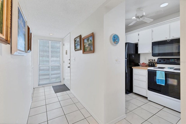 kitchen featuring black appliances, ceiling fan, light tile patterned flooring, and white cabinetry