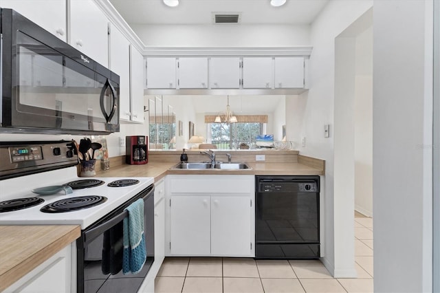 kitchen with light tile patterned floors, sink, white cabinets, and black appliances