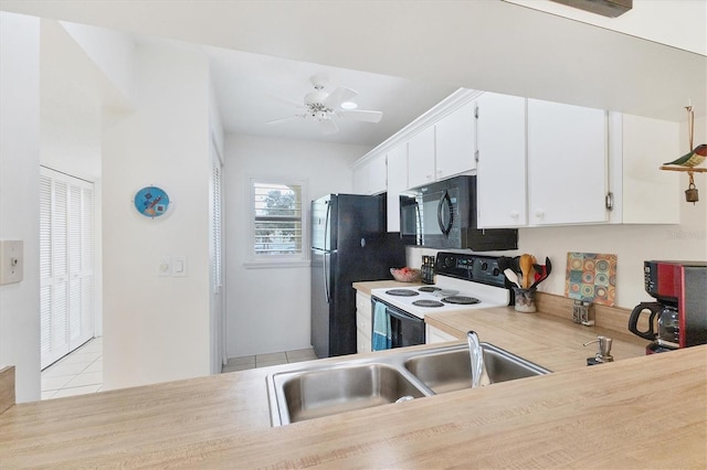 kitchen with ceiling fan, black appliances, sink, white cabinetry, and light tile patterned floors