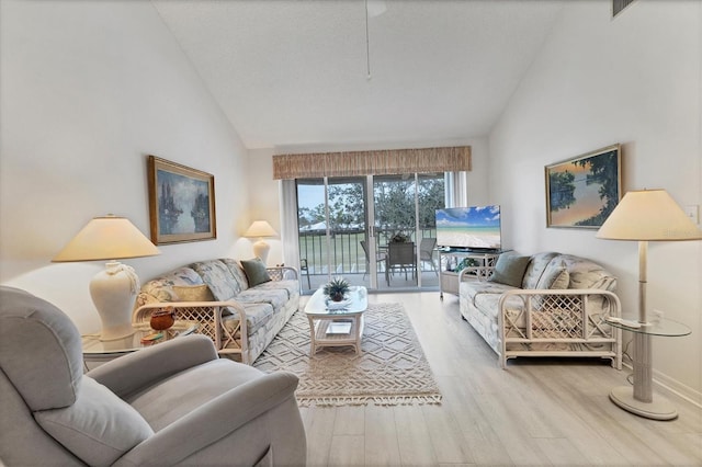 living room featuring vaulted ceiling and wood-type flooring