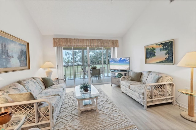 living room with wood-type flooring and vaulted ceiling