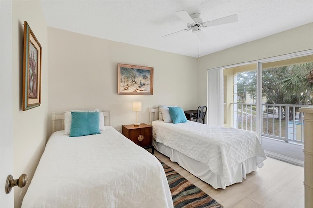 bedroom with ceiling fan, access to exterior, a textured ceiling, and light hardwood / wood-style flooring