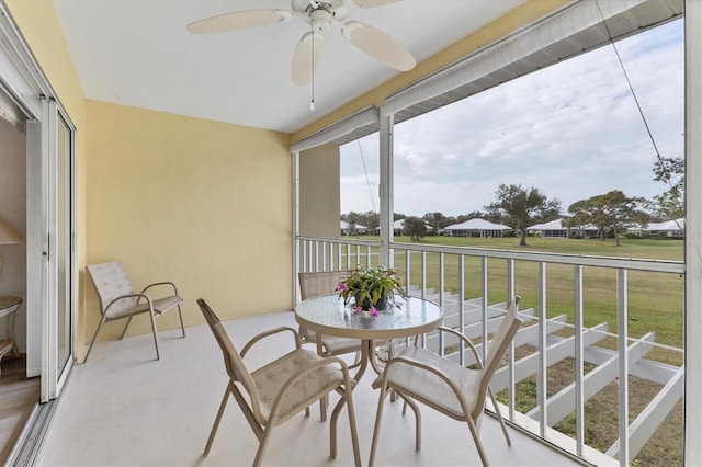 sunroom / solarium featuring ceiling fan