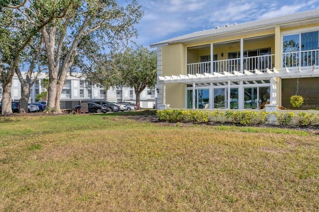 rear view of house featuring a lawn