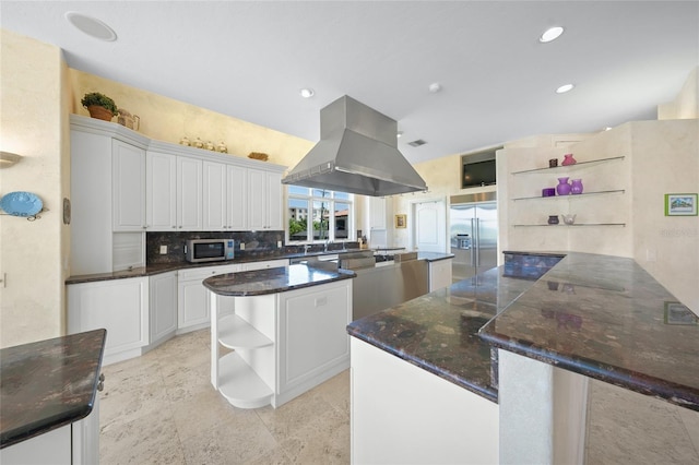 kitchen with white cabinetry, island exhaust hood, a kitchen island, decorative backsplash, and stainless steel appliances