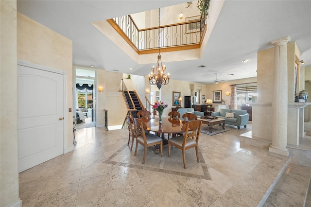 dining room featuring decorative columns and an inviting chandelier