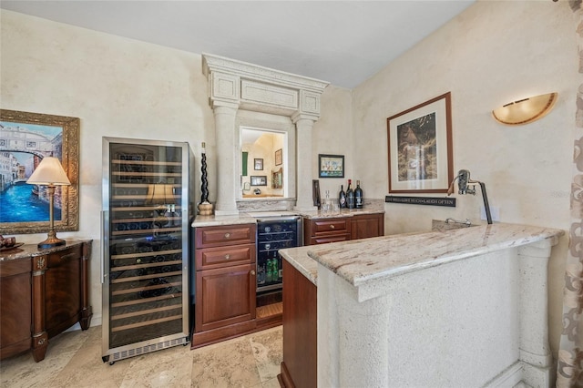 bar with light stone counters and beverage cooler