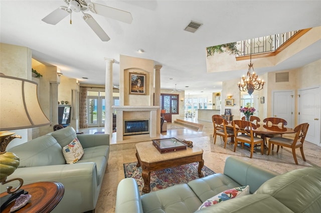 living room featuring ceiling fan, a high end fireplace, ornate columns, and light tile patterned flooring